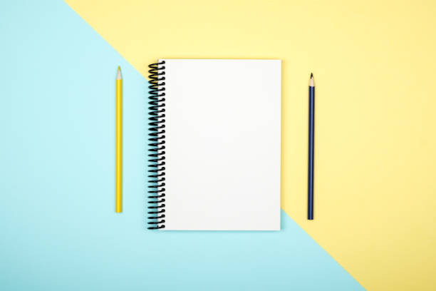 istock Top view of open spiral blank notebook on colorful desk background 879028416
