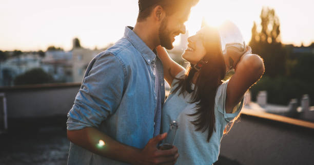 istock Couple flirting while having a drink on rooftop terrasse 879028502