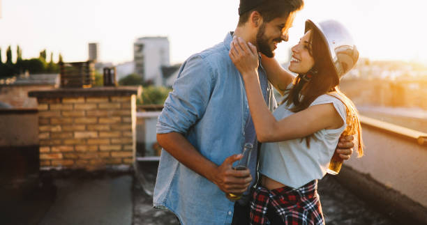 istock Couple flirting while having a drink on rooftop terrasse 879028540