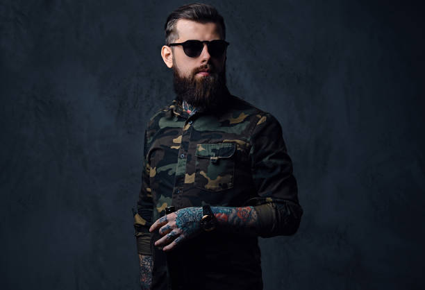 istock A man dressed in military shirt, drinks craft beer. 879030922