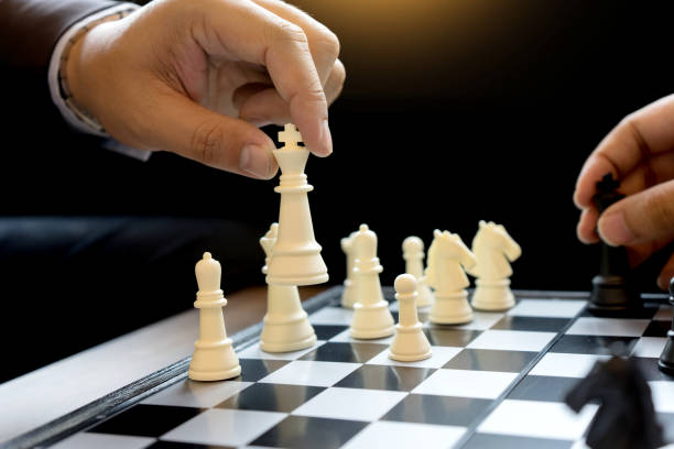 istock Businessman play chess use King Chess Piece white to crash overthrow 879032000