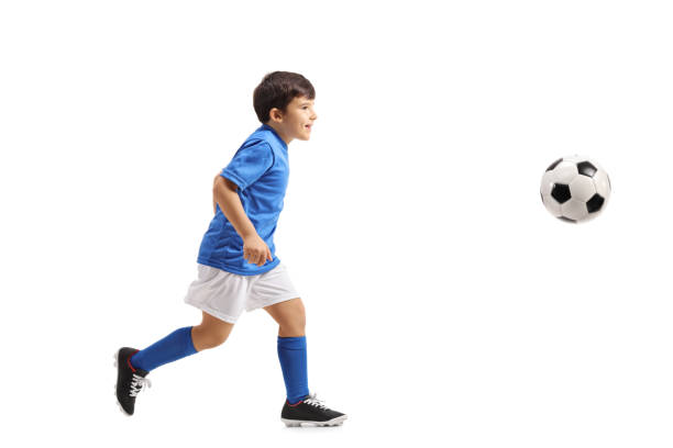 istock Little footballer running 879032086