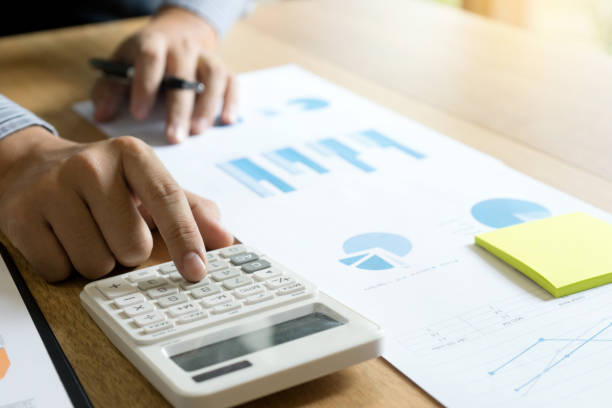 istock businessman use a finger to calculator for work 879038400