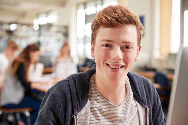 istock Portrait Of Male Student Working On Computer In College Library 879041044