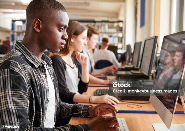 Group Of Students Using Computers In College Library Stock Photo - Download Image Now