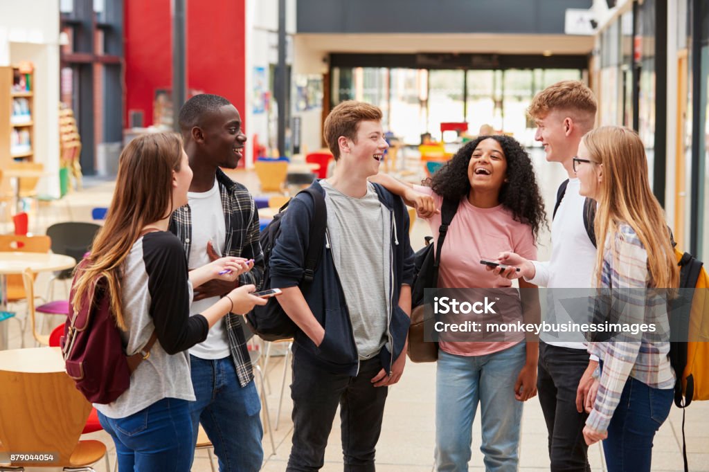 Student Group Socializing In Communal Area Of Busy College Teenager Stock Photo