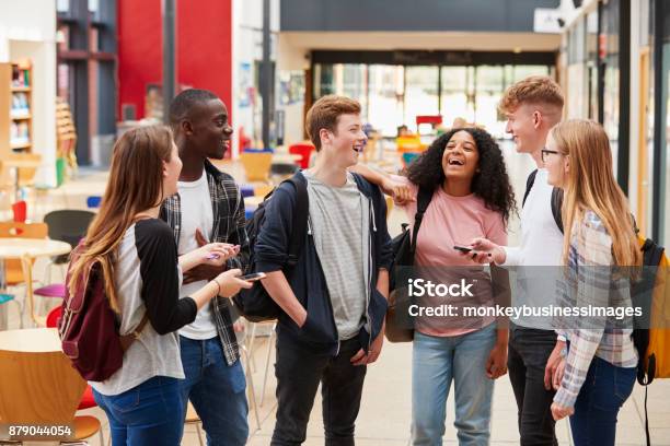 Student Group Socializing In Communal Area Of Busy College Stock Photo - Download Image Now