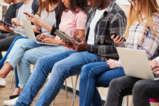 istock Close Up Of Seated College Students Using Digital Technology 879045212