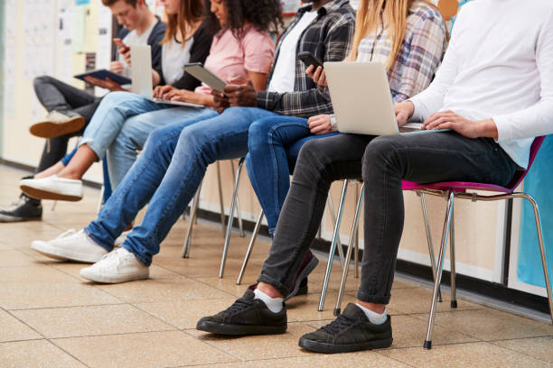 istock Close Up Of Seated College Students Using Digital Technology 879045214