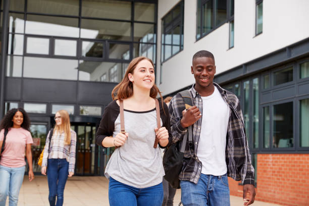 istock Group Of Students Walking Outside College Buildings 879045216