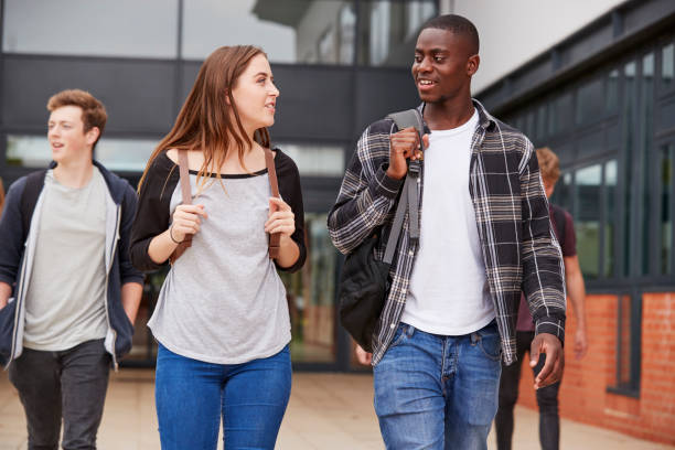 istock Group Of Students Walking Outside College Buildings 879048102