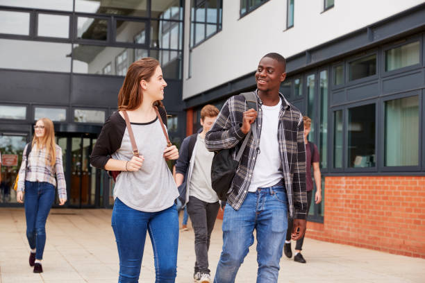 istock Group Of Students Walking Outside College Buildings 879048110