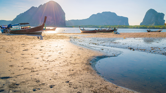 Beautiful sunset at tropical sea with long tail boat in south thailand