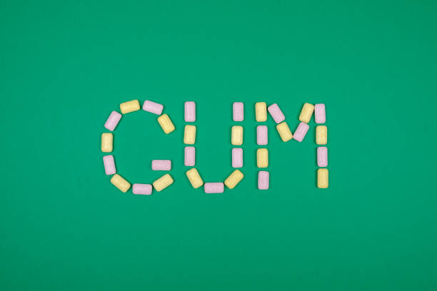 istock Word GUM written with chewing gum on green background 879055142