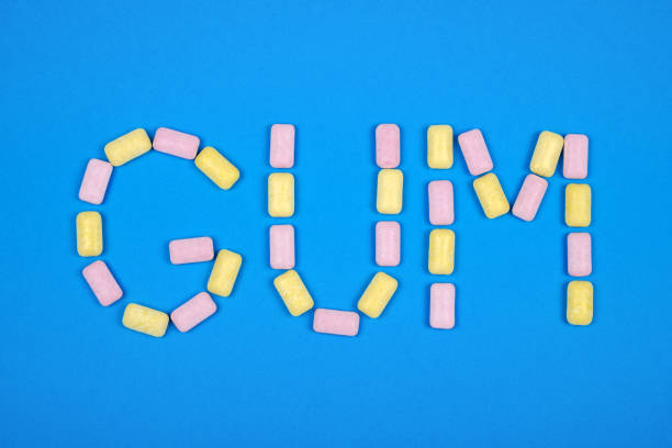 istock Word GUM written with chewing gum on blue background 879055268