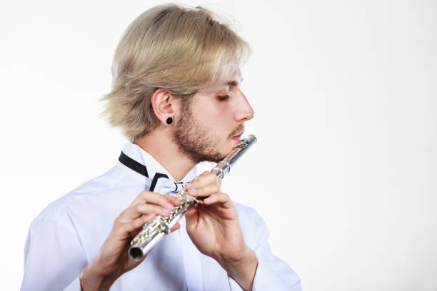 istock Male flutist playing his flute 879058340