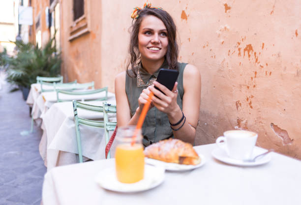 istock Young beautiful woman having breakfast in Rome 879058432