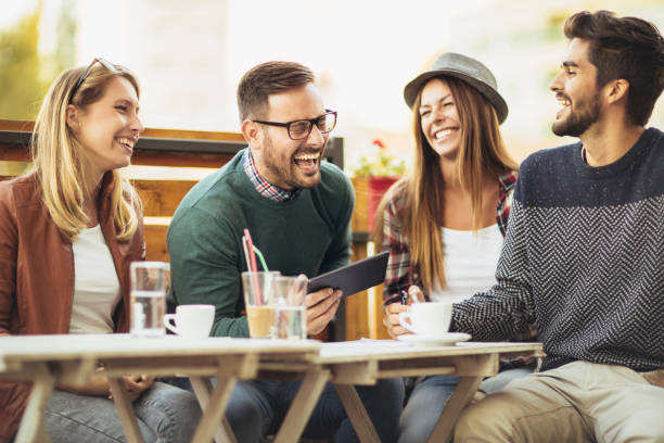 istock Group of four friends having fun a coffee together 879058872