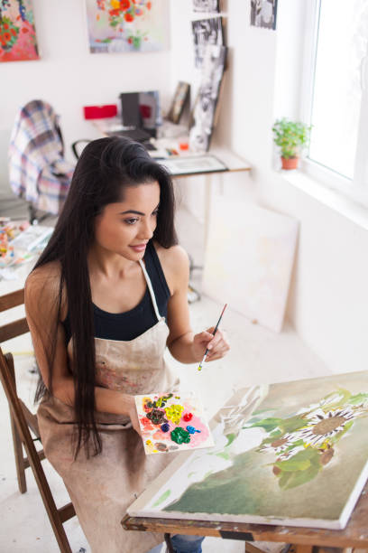 istock Smiling young artist drawing in atelier 879059178