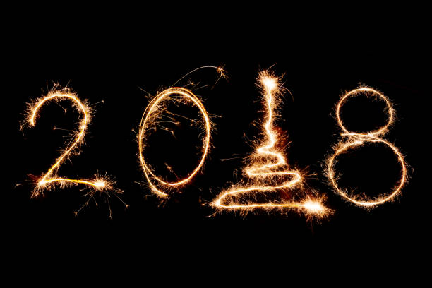istock 2018 written with Sparkle firework on black background, happy new year 2018 concept 879065826