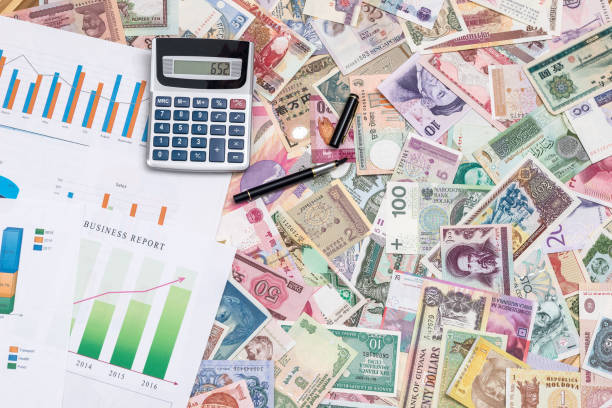istock business graph with world paper currency 879069294