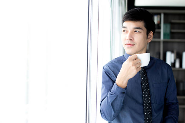 istock Asian Businessman drinking coffee at the morning. 879070094