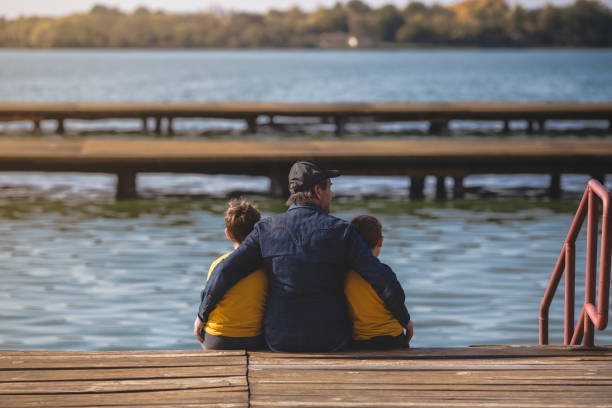 istock Grandfather and his grandsons playing outdoors 879070788