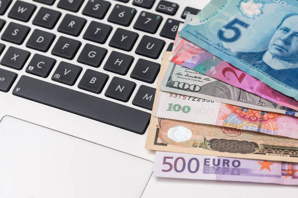 istock most world paper money with laptop 879075590