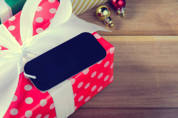 istock Gift Box Present on a wooden table with Christmas 879076054