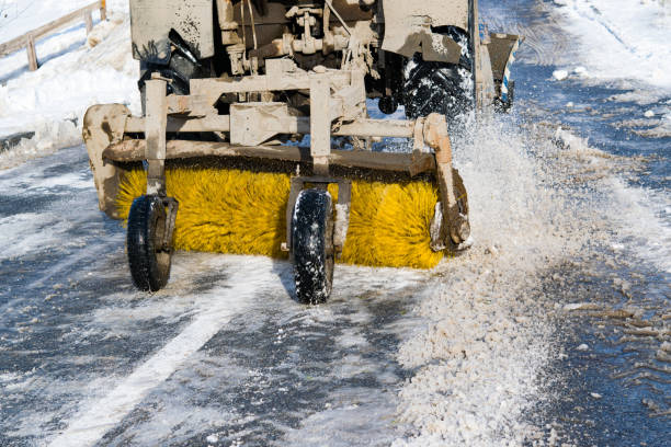 istock Snowblower with the sweeper brush cleans snow on the road 879090622