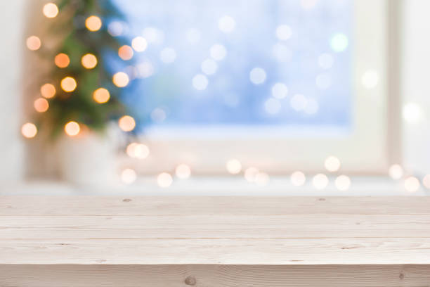 empty wooden table in front of blurred winter holiday background - window sill imagens e fotografias de stock
