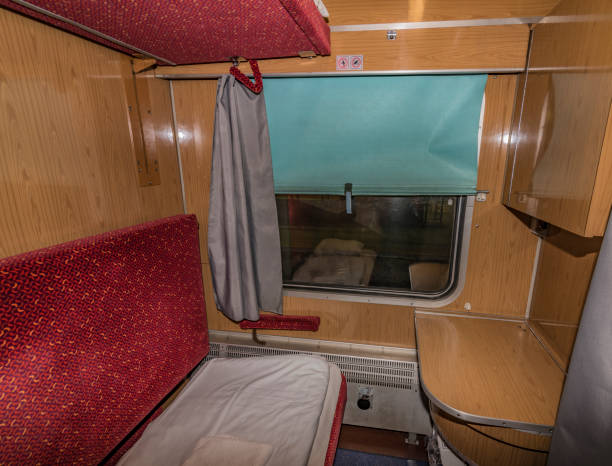 istock Interior of night train with beds and wash basin 879109426