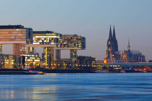 Skyline of Cologne Cathedral and the Crane Buildings (Kranhäuser) at sunset, Cologne, Germany