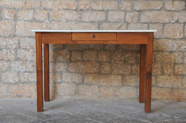 istock A wooden table against a stone 879126014