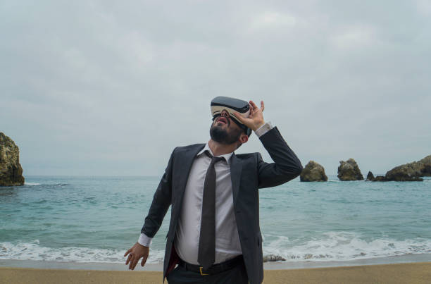 istock Businessman with Virtual Reality Use  on the Beach 879130260