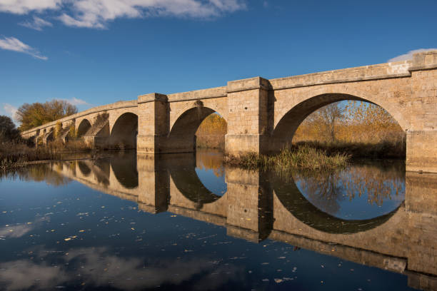 istock Fitero bridge, medieval bridge over Pisuerga river Palencia, Spain. 879130864
