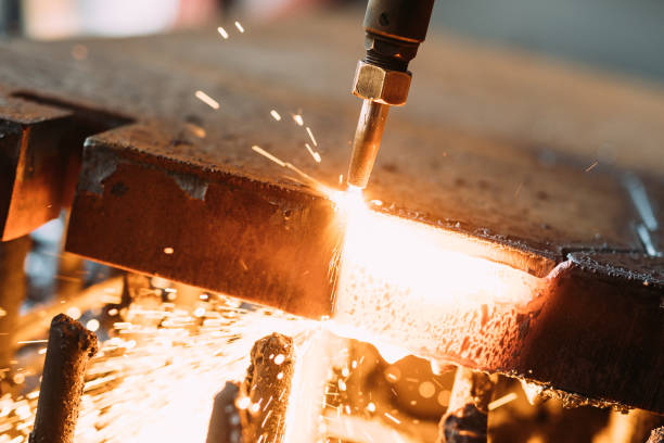 istock Oxygen torch cuts steel sheet. CNC gas cutting machine. Bright sparks 879134112