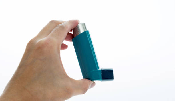 istock Man hand holding an asthma inhaler 879134504