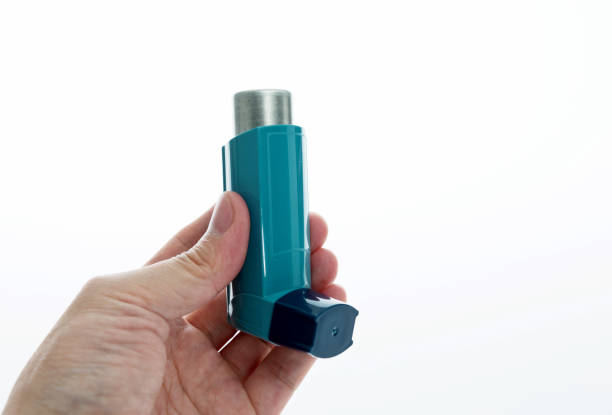 istock Man hand holding an asthma inhaler 879134524