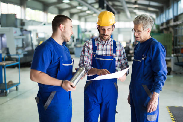istock Team Of Engineers Having Discussion In Factory 879136886