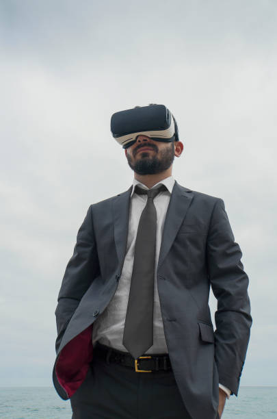 istock Businessman with Virtual Reality Use  on the Beach 879151350