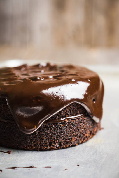 istock Creamy cake with chocolate glaze on the rustic background 879151368