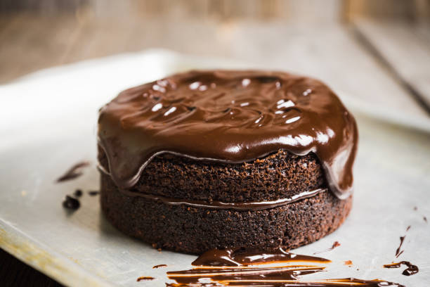 istock Creamy cake with chocolate glaze on the rustic background 879151374