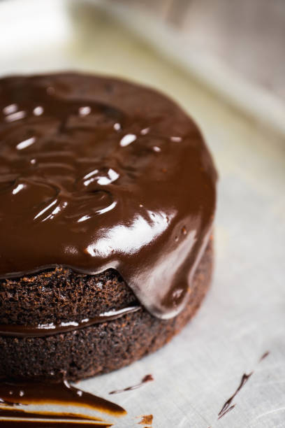 istock Creamy cake with chocolate glaze on the rustic background 879151382