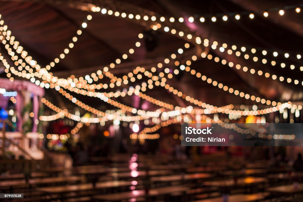 Blurred Beer Tent Blurred beer tent, tables, benches, blurry decorative light, London, UK. Traveling Carnival Stock Photo