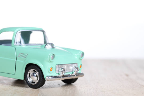istock miniature car on wooden floor isolated on white background 879153898