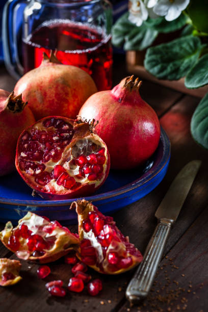 istock Fresh organic pomegranates on rustic wooden table 879154478
