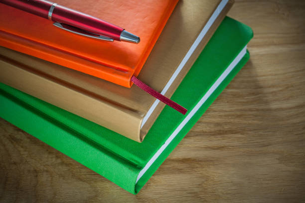istock Office notebooks ballpoint pen on wooden board 879154574