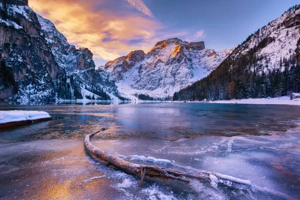 winter sunrise with colorful cloudscape over Lago di Braies, Dolomites, Italy