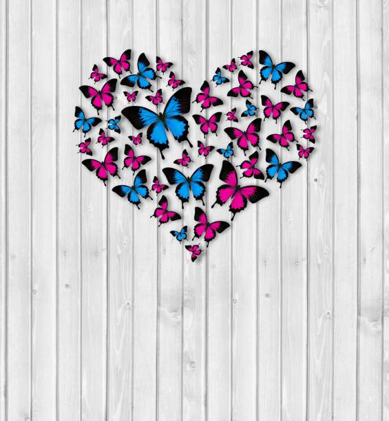 heart shape and hands on a wooden background from butterflies